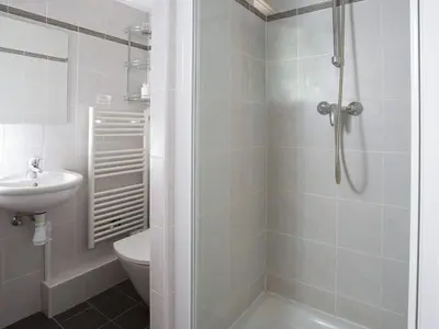 a bathroom with a shower and a toilet and a sink at Apartment Le Paradis Ski Wohnung by Interhome in Chamonix-Mont-Blanc