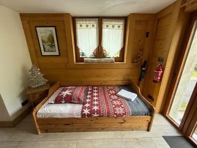 a bedroom with a bed in a wooden room at Chalet Du Goûter Room Bionnassay, Les Houches in Les Houches