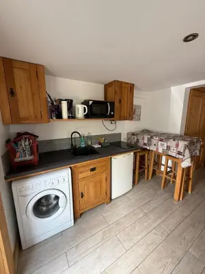 a kitchen with a washing machine and a counter at Chalet Du Goûter Room Bionnassay, Les Houches in Les Houches