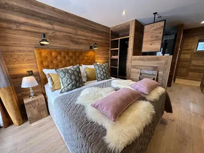 a bedroom with a large bed with pillows on it at Chalet Khione in Chamonix-Mont-Blanc