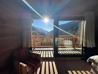 a bedroom with a balcony with a view of a mountain at Chalet Khione in Chamonix-Mont-Blanc