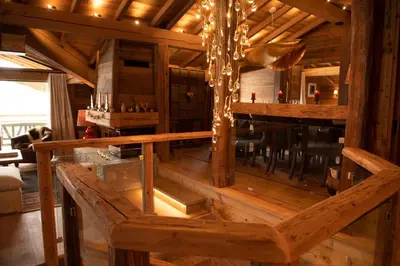 a room with a bar in a wooden house at Chalet Khione in Chamonix-Mont-Blanc