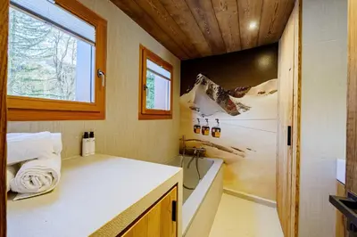a small bathroom with a sink and a window at Modern Alpine Chalet a c 4BR 7P - Megève in Megève