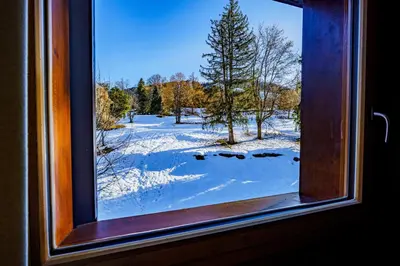 a window with a view of a snow covered field at Modern Alpine Chalet a c 4BR 7P - Megève in Megève