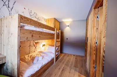 a large wooden bunk bed in a room at Modern Alpine Chalet a c 4BR 7P - Megève in Megève