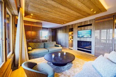 a living room with a couch and a table at Modern Alpine Chalet a c 4BR 7P - Megève in Megève