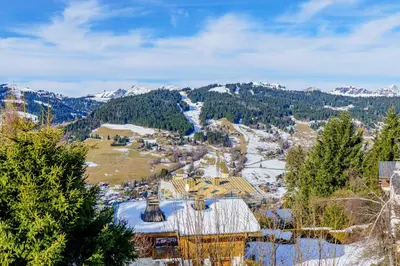 an aerial view of a resort with snow covered mountains at Modern Alpine Chalet a c 4BR 7P - Megève in Megève