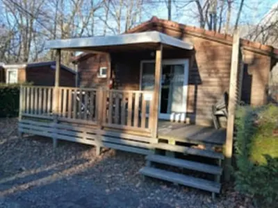 a log cabin with a porch and a deck at Camping Les Iles in Passy