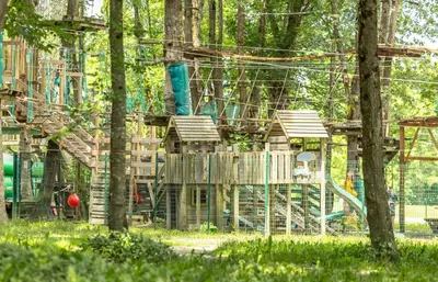 a park with a playground with a slide at Camping Les Iles in Passy