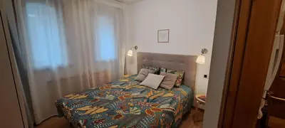 a bedroom with a bed with a colorful comforter at L'Alp'Inn - 4 pax, Chamonix Valley - Cozy Flat, Ski & Supermarket in Les Houches