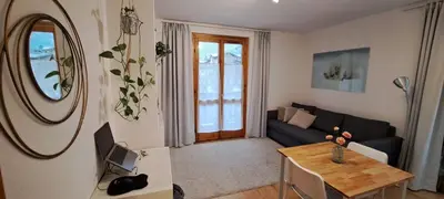 a living room with a couch and a table at L'Alp'Inn - 4 pax, Chamonix Valley - Cozy Flat, Ski & Supermarket in Les Houches