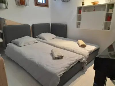two beds with pillows on them in a room at Chalet mitoyen au calme - rez-de-jardin - parking in Les Houches
