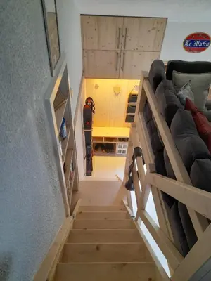 a person on a skateboard walking down a stairs at Chalet mitoyen au calme - rez-de-jardin - parking in Les Houches