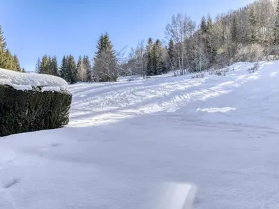 a snow covered road with trees in the background at Appartement 3 Chambres, Terrasse Sud/Ouest, Parking - Megève - FR-1-453-331 in Megève
