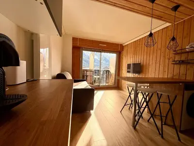 a living room with a table and a dining room at Appt 4 pers Chamonix in Chamonix-Mont-Blanc