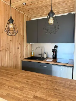 a kitchen with two lights hanging from the ceiling at Appt 4 pers Chamonix in Chamonix-Mont-Blanc