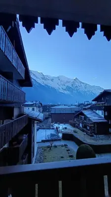 a view of a snowy mountain from a window at Appt 4 pers Chamonix in Chamonix-Mont-Blanc