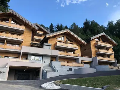 a building with balconies on the side of it at Appartement dans Chalet aux pieds des pistes in Arâches-la-Frasse
