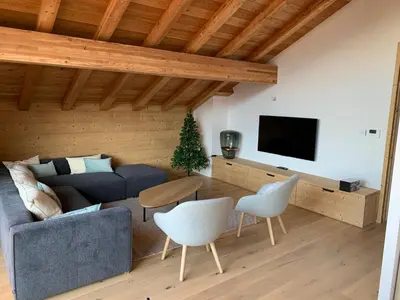 a living room with a couch and a table at Appartement dans Chalet aux pieds des pistes in Arâches-la-Frasse