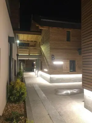 an empty hallway of a building at night at Appartement dans Chalet aux pieds des pistes in Arâches-la-Frasse