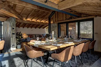 a dining room with a large wooden table and chairs at Papillon Chamonix Chalet in Chamonix-Mont-Blanc