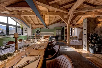a dining room with a long wooden table and chairs at Papillon Chamonix Chalet in Chamonix-Mont-Blanc