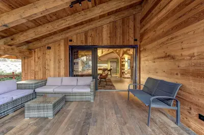 a living room of a log cabin with couches and chairs at Papillon Chamonix Chalet in Chamonix-Mont-Blanc