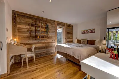a bedroom with a bed and a desk at Papillon Chamonix Chalet in Chamonix-Mont-Blanc