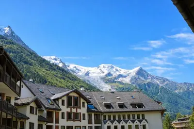 a view of snowy mountains from a building at Apartment near Aiguille du Midi with balcony in Chamonix-Mont-Blanc