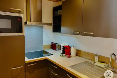 a small kitchen with a sink and a microwave at Apartment near Aiguille du Midi with balcony in Chamonix-Mont-Blanc