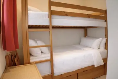 a room with two bunk beds and a table at Apartment near Aiguille du Midi with balcony in Chamonix-Mont-Blanc