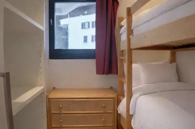 a bedroom with a bunk bed and a window at Apartment near Aiguille du Midi with balcony in Chamonix-Mont-Blanc
