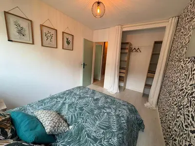 a bedroom with a bed with a blue blanket at Modern Alpine Gem Flat with mountain views in Sallanches
