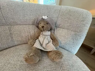 a stuffed teddy bear sitting on a couch at Modern Alpine Gem Flat with mountain views in Sallanches