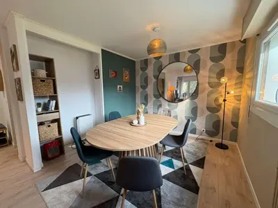 a dining room with a table and chairs and a mirror at Modern Alpine Gem Flat with mountain views in Sallanches