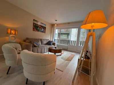 a living room with a couch and a table at Modern Alpine Gem Flat with mountain views in Sallanches