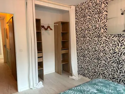 a bedroom with a black and white patterned wall at Modern Alpine Gem Flat with mountain views in Sallanches