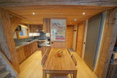 a kitchen with a wooden table in a cabin at Warm Alpine apartment 2BR 5P - Megeve in Megève