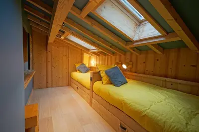 two beds in a cabin with a skylight at Warm Alpine apartment 2BR 5P - Megeve in Megève