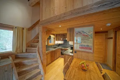 a kitchen with wooden walls and a wooden table at Warm Alpine apartment 2BR 5P - Megeve in Megève