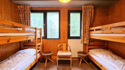a room with two bunk beds and a chair at Résidence Aldebaran - Appartement spacieux avec casier à ski · Ski aux pieds · Balcon MAE-4994 in Magland