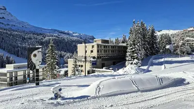 a snow covered slope with a building in the background at Résidence Aldebaran - Appartement lumineux · Au pied des pistes · Balcon MAE-5014 in Magland