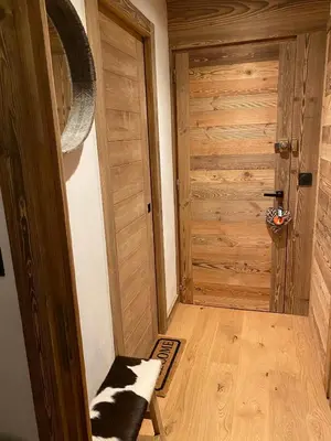 a room with a wooden door and a wooden floor at Megeve-Fully renovated Appartment- 10mn from village in Megève