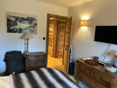 a bedroom with a bed and a flat screen tv at Megeve-Fully renovated Appartment- 10mn from village in Megève