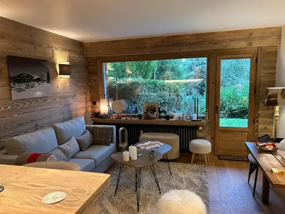 a living room with a couch and a table at Megeve-Fully renovated Appartment- 10mn from village in Megève