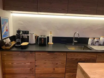 a kitchen with a counter with a sink and a counter top at Megeve-Fully renovated Appartment- 10mn from village in Megève