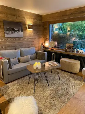 a living room with a couch and a table at Megeve-Fully renovated Appartment- 10mn from village in Megève