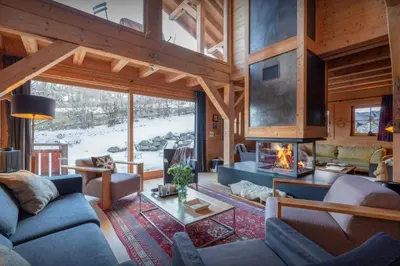 a living room with a fireplace in a cabin at Chalet Uska - OVO Network in Combloux