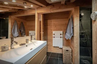 a bathroom with a large white sink and a shower at Chalet Uska - OVO Network in Combloux