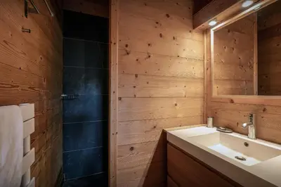 a bathroom with a sink and a mirror at Chalet Uska - OVO Network in Combloux